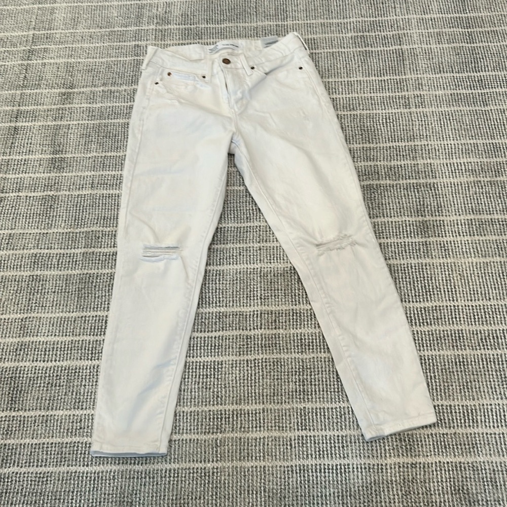 Levi slightly worn white jeans with rips.